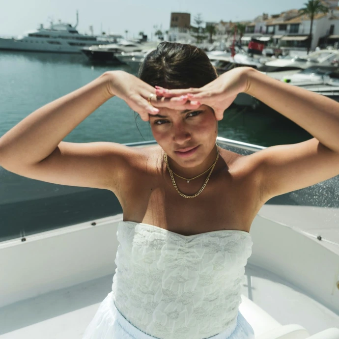A woman in a white dress on a boat